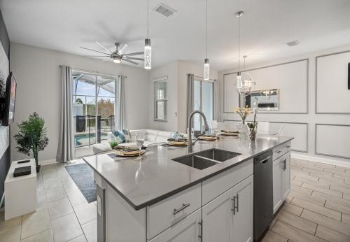 a kitchen with a sink and a counter top at Luxury Townhouses 18 Minutes away from Disney! in Kissimmee