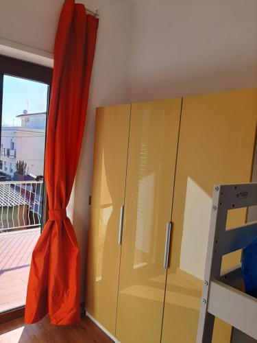 a bedroom with a yellow cabinet and a window at Casa Annalisa in Scauri