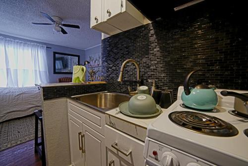 a kitchen with a sink and a stove top oven at SHALIGOHOMES QUEEN SUITE ON 16TH in Anchorage