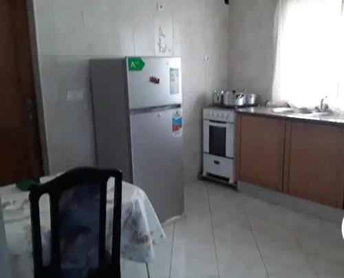 a kitchen with a refrigerator and a stove at Casa dos Amigos in Calheta de São Miguel