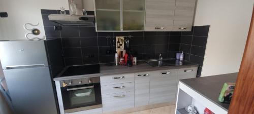 a kitchen with a sink and a refrigerator at A PLACE TO REMEMBER in Montegrosso dʼAsti