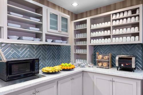 a kitchen with a microwave and fruit on a counter at Hyatt Place-Dallas/Arlington in Arlington