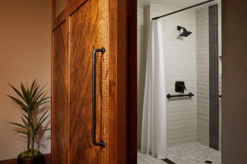 a shower with a glass door in a bathroom at Hyatt Place Fort Worth Stockyard in Fort Worth