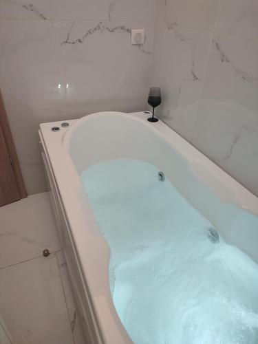 a bath tub filled with water in a bathroom at Amazing Apartments @ Monastiraki Subway Station in Athens