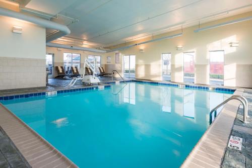 a swimming pool with chairs in a building at Hyatt Place Lexington in Lexington