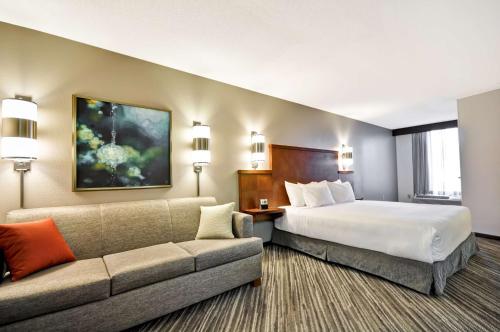 a hotel room with a bed and a couch at Hyatt Place Minneapolis Eden Prairie in Eden Prairie