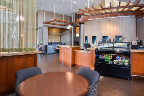 a restaurant with a table and a drink bar at Hyatt Place Chesapeake in Chesapeake