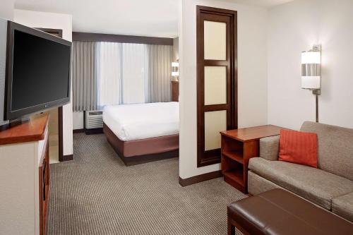 a hotel room with a bed and a television at Hyatt Place Ontario/Rancho Cucamonga in Ontario
