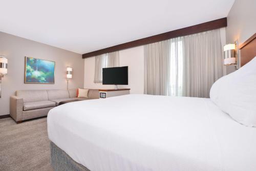 a large white bed in a hotel room at Hyatt Place Chesapeake in Chesapeake
