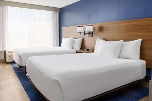 two beds in a hotel room with white pillows at Hyatt Place across from Universal Orlando Resort in Orlando