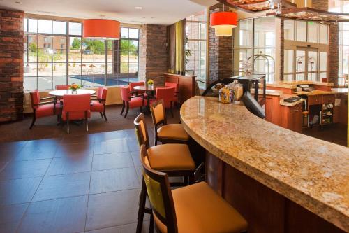 a bar in a restaurant with chairs and tables at Hyatt Place Santa Fe in Santa Fe