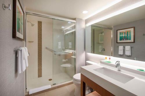 a bathroom with a shower and a sink and a toilet at Hyatt Place Durham Southpoint in Durham