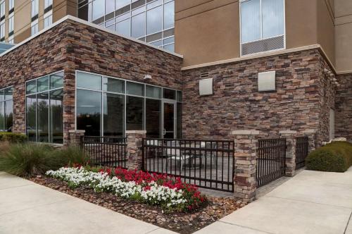 a building with flowers in front of a building at Hyatt Place San Antonio North Stone Oak in San Antonio