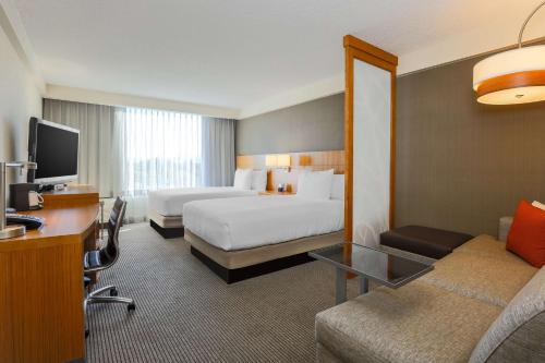 a large hotel room with two beds and a desk at Hyatt Place San Jose, Downtown in San Jose