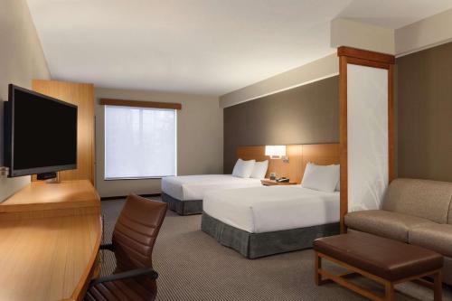 um quarto de hotel com duas camas e uma televisão de ecrã plano em Hyatt Place St. Louis/Chesterfield em Chesterfield