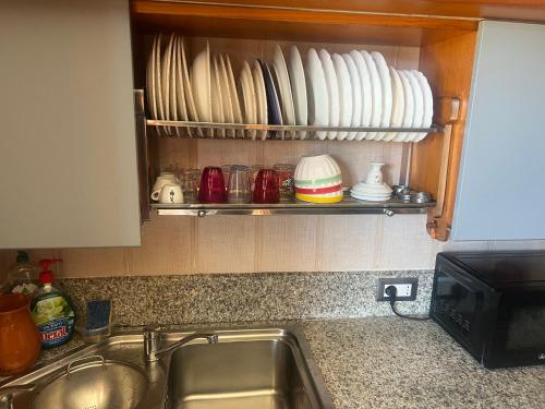 a kitchen counter with a sink and some dishes at Chez Moi rooms in Cagliari