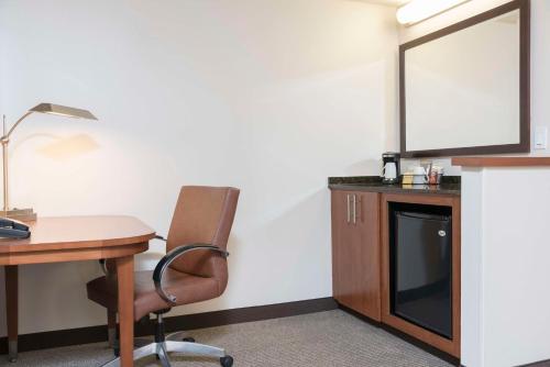 an office with a desk and a chair and a television at Hyatt Place Sarasota/Bradenton in Sarasota
