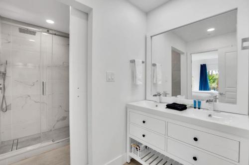 a white bathroom with a sink and a shower at Casa Magical 1mile to Disney in Orlando