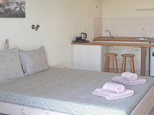 a bedroom with a bed with towels on it at FLORA STUDIOS CORFU - Adults only in Benitses