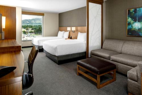 a hotel room with two beds and a couch at Hyatt Place Boulder/Pearl Street in Boulder