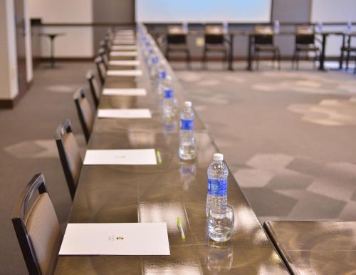 a long table with bottles of water on it at Hyatt Place Garden City in Garden City