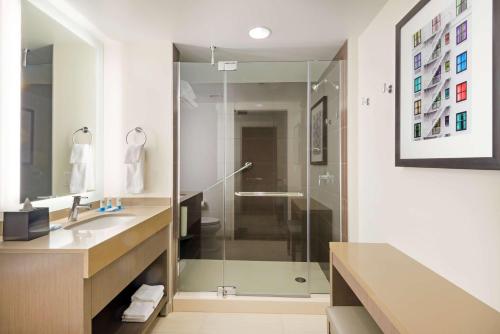 a bathroom with a glass shower and a sink at Hyatt House Denver/Downtown in Denver