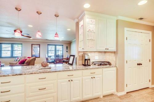 a kitchen with white cabinets and a living room at HOT TUB - Beautifully Renovated Home in West Texas in Fort Stockton