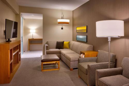 a living room with a couch and a tv at Hyatt Place Park City in Park City