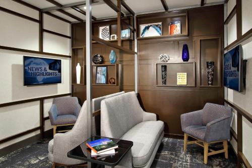 a waiting room with a couch and two chairs at Hyatt Place Houston/Katy in Katy