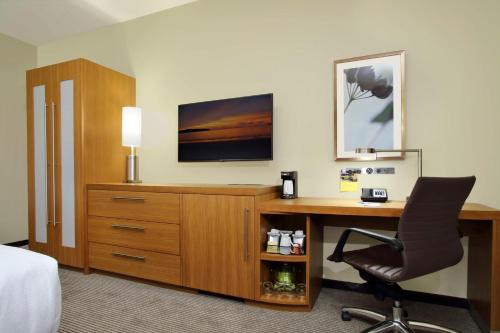 a hotel room with a desk and a chair at Hyatt Place Houston/Katy in Katy