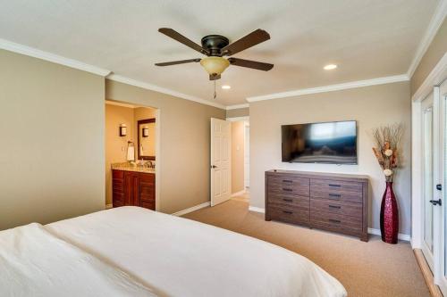 a bedroom with a bed and a flat screen tv at HOT TUB - Beautifully Renovated Home in West Texas in Fort Stockton