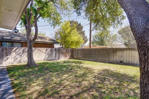 a yard with two trees and a fence at HOT TUB - Beautifully Renovated Home in West Texas in Fort Stockton