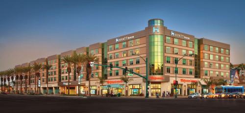 a large building on a city street with a traffic light at Hyatt House at Anaheim Resort/Convention Center in Anaheim