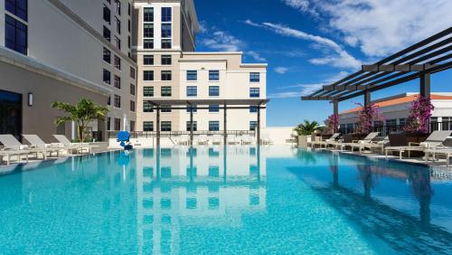 a large swimming pool in front of a building at Hyatt Place Boca Raton in Boca Raton