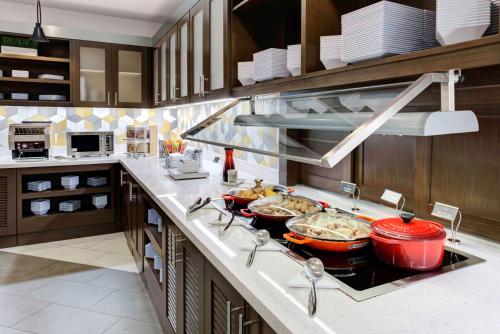 a kitchen with several bowls of food on a counter at Hyatt Place Dallas/Allen in Allen