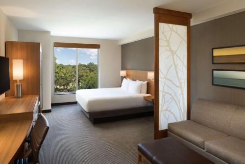 a hotel room with a bed and a window at Hyatt Place Biloxi in Biloxi