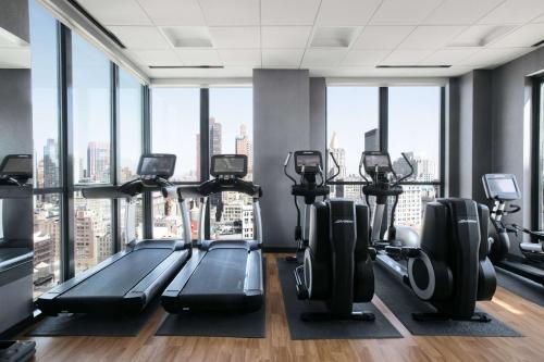 a gym with treadmills and elliptical machines at Hyatt House New York/Chelsea in New York