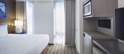 a hotel room with a bed and a tv at Hyatt House New York/Chelsea in New York