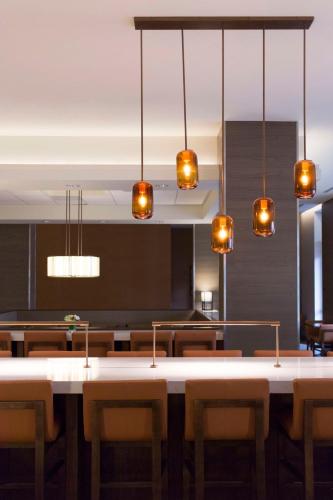a dining room with a table and chairs at Hyatt House Charleston - Historic District in Charleston