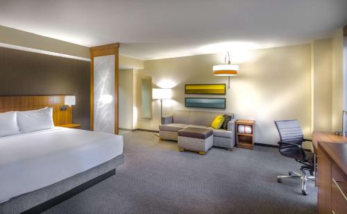 a hotel room with a bed and a couch at Hyatt Place Washington D.C./National Mall in Washington