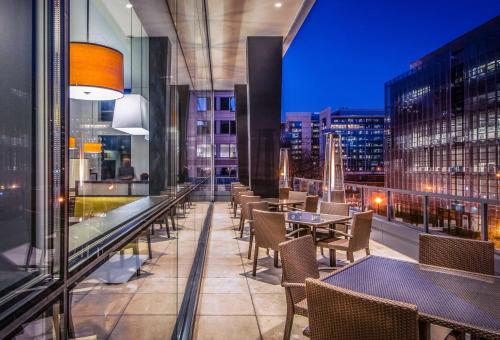 a restaurant with tables and chairs on a balcony at Hyatt Place Washington D.C./National Mall in Washington