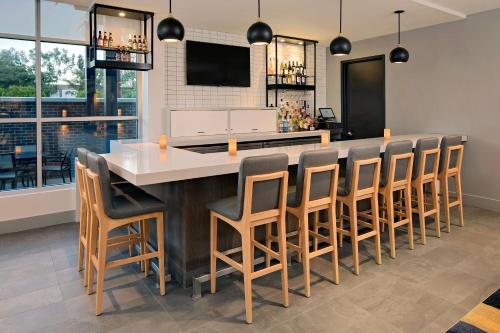 a large kitchen with a bar with stools at Hyatt House Irvine/John Wayne Airport in Irvine
