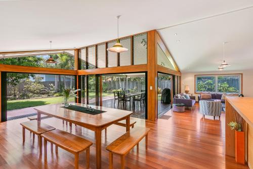 a large living room with a table and chairs at Cabarita Beach Oasis - 3BR Beach House by uHoliday in Cabarita Beach