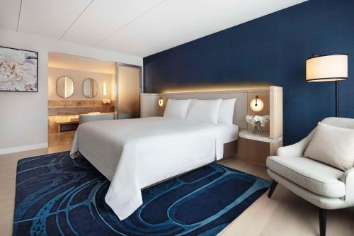 a bedroom with a large white bed and a chair at Hyatt Regency Sydney in Sydney