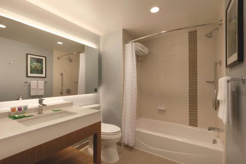 a bathroom with a sink and a tub and a toilet at Hyatt Place Washington DC/Georgetown/West End in Washington