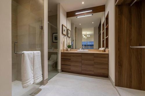 a bathroom with a shower and a sink and a toilet at Villa San Lucas - Luxury 4BR Penthouse in Cabo San Lucas