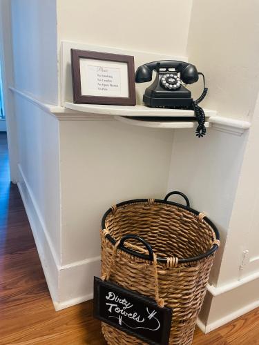 a phone sitting on a shelf next to a basket at Excelsior at the Manor House in Clemmons