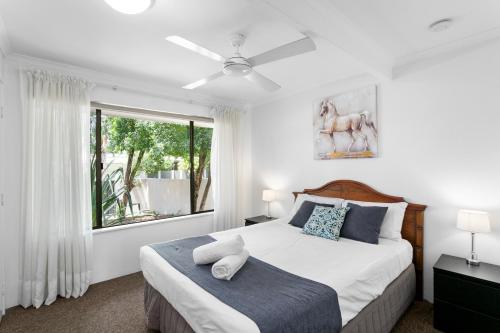 a bedroom with a large bed and a window at Nautilus Noosa Holiday Resort in Noosaville