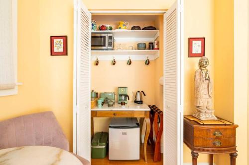 a small room with a desk and a kitchen at Secret Garden Stay - Perfect SF Location in San Francisco