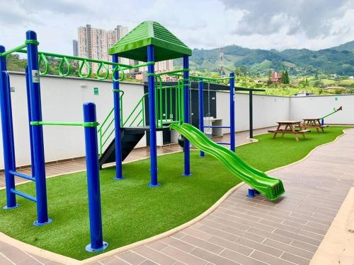 a playground on the roof of a building with a slide at Moderno Apartamento en Sabaneta / Medellín in Sabaneta